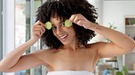 Black woman, smile and fruit eyes for skincare nutrition, health or wellness dance in beauty cosmetics at home. African American female afro smiling for healthy diet holding cucumber for facial care