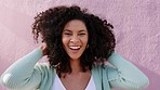 Portrait of black woman touching her afro outdoor by a pink wall while embracing her curls. Happy, latino and goofy girl embracing her natural hair with a haircare, wellness and beauty lifestyle.