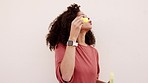 Happy black woman, blowing bubbles and fun smile in playful happiness against a studio background. Beautiful African female smiling dipping wand in soap water and enjoying bubble time in the outdoors