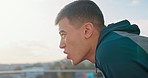 Tired, breathing and sweating fitness, man outdoor for running, exercise and cardio training at a seaside promenade. Athlete exhausted after workout, run and sport for health, energy and wellness