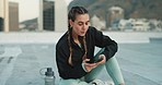 Phone, exercise and woman on social media while sitting on a rooftop on workout break outdoor. Fitness, communication and girl athlete networking on the internet with smartphone after cardio training