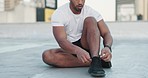 Fitness, man and shoes in preparation for sports training, exercise or workout in the outdoors. Hands of male tying shoe laces getting ready for sport run, cardio or healthy exercising outside