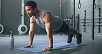 Fitness, man and pushups for muscle, exercise or training workout for strength or power at the gym. Athletic male in sport exercising lifting body with arms on the floor for strong muscles indoors