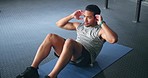 Fitness, man and doing sit ups for wellness, health and motivation doing workout routine, exercise and training in gym on floor. Male trainer, athlete and movement being healthy, strong and focus.