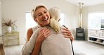 Friends, greeting and senior women hug in living room for visit, bonding and quality time together. Love, friendship and mature females in living room hugging, embrace and talking with happiness
