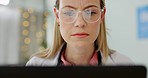 Healthcare, laptop and doctor focus reading email communication, internet research or medical data report writing. Cardiology professional health care woman with glasses and computer software app