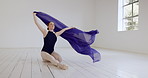 Ballerina dancer, sitting and floor with fabric in classroom, rehearsal or studio for performance. Woman, dancing and cloth for art, training or ballet at dance college, school or academy for concert