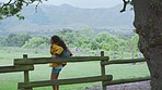 Backpack, travel and nature with an indian woman outdoor to relax while enjoying a summer vacation. Spring, tree and park with a female walking on a green grass field in a natural environment