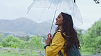 Rain, hiking and woman with umbrella in nature, happy and relax, smile and zen, freedom and adventure. Weather, raining and travel by girl backpacker exploring a jungle, calm and peace in Ecuador