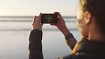 Phone, beach and travel with a woman tourist taking a photograph at sunset for sightseeing with mockup. Water, mobile and summer with a female recording a video for social media outdoor in nature