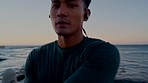 Stretching, running and face of man at beach for fitness, cardio and workout in Taiwan. Warm up, start and portrait of an Asian athlete with music for training motivation during sunset with handheld