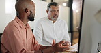 Teamwork, human resources and training with a business black man talking to a colleague while working on a computer. Meeting, planning and collaboration with a team at work together in an office
