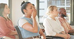 Audience, presentation and tired business woman yawning with fatigue while in a meeting listening to a training workshop. Diversity men and women group together at a seminar to listen to speech