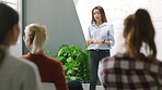 Meeting, presentation and data with a business woman teaching her team using a whiteboard in the office. Training, coaching and statistics with a female employee coaching staff in the boardroom