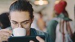 Man, phone and coffee shop drinking espresso or tea while reading, watching or streaming wifi connection for esports, ebook or video. Geek with glasses for software, download and programming in cafe