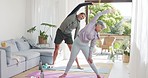 Fitness, exercise and senior couple in home doing workout, yoga and pilates in living room together. Wellness, health and elderly man and woman exercising, stretching and cardio training on yoga mat