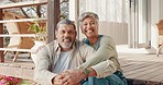 Senior couple, love and hug outdoor at home porch, bonding and smiling. Portrait, relax and retired, elderly and happy man and woman sitting on veranda outside house enjoying quality time together.