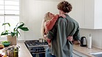 Couple, dance and kiss in kitchen, love and care with strong relationship and fun dancing together at home. Affection, bonding and happy with romance for relationship, relax and spending quality time