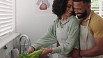 Couple, bonding and cleaning vegetables in water in the kitchen sink while talking with happiness. Food, man and woman communicating with hygiene for produce before cooking or preparing a meal