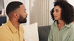 Argue, disagree and unhappy with a black couple talking in the living room of their home during a discussion. Communication, conversation and angry with a man and woman arguing on a sofa in the house