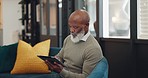 Tablet, technology and senior black man on sofa browse online website, social media and internet. Online shopping, retirement and elderly male enjoy freedom, weekend and relax with digital tech