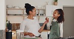 Fruit, mother and girl cooking breakfast or healthy food or tasting in meal preparation in home kitchen. Banana, strawberry or mom teaching a happy kid for growth or child development as a family