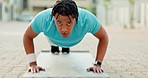 Push up, black man and city fitness, exercise and mindset, workout challenge and focus for health in Brazil. Bodybuilder, portrait and push up on ground for training, wellness and strong motivation 