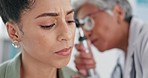 Healthcare, doctor and ear exam of black woman in hospital. Consultation, otolaryngology and mature female physician or ent specialist with otoscope testing patient for tinnitus or hearing problems.