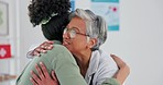 Doctor, patient and hug for healthcare appointment, consultation or checkup at the hospital. Elderly medical professional hugging female in care after exam, diagnosis or prescription at the clinic