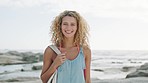 Woman, beach and travel with a smile, happiness and freedom while on holiday with a bag in nature for peace, calm and zen time. Face portrait of female from Sweden on vacation at sea with curky hair