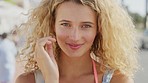 Blonde woman, face and happy tourist on holiday feeling peaceful and calm in summer. Beautiful female, portrait and youth holiday smiling while on a travelling vacation in an urban city 