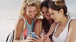 Women, beach and phone for laugh, social media meme or joke on internet with bonding vacation together. Woman friends, smartphone and funny blog post on social network, web or app in San Francisco