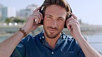 Happy man, headphones and beach in background for listening to music, travel and freedom with peace, calm and happiness outdoor. Face portrait of a male with  smile and positive mindset at Bali sea