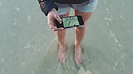 Phone picture, sea waves and feet in the ocean water with mobile, travel and summer vacation. Woman journey on the beach with freedom and 5g internet taking a adventure photo for social media 