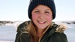 Child, face and happy girl at beach with winter clothes and tongue out and excited about fun activity on nature holiday in Dublin. Portrait kid with funny expression and warm hat and jacket outdoor