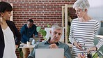 Corporate, office and senior employees in discussion analyzing company statistics, data and documents online. Communication, laptop and elderly business people working on a project together in office