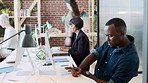 Black man, computer and coworking workplace with team of working online and writing notes about data analytics, marketing research and CRM report. Creative employees with desktop technology in office