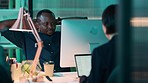 Computer, office and tired black man at night while working late, stretching and thinking and doing online work for marketing, CRM and sales at desk. Team or employees with technology for deadline