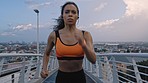 Black woman, runner and athlete training in city for cardiovascular exercise, running on bridge and body health workout. Sports fitness girl, urban run in town and training for a marathon competition