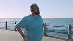 Weightloss, fitness and man running by ocean for body health, cardio wellness and workout goals. Sports, nature and plus size male do exercise, marathon training and jog by sea for healthy lifestyle