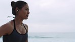 Woman, running and beach music at sunset with earphones for athlete marathon training in Brazil. Exercise, fitness and focus of runner girl at ocean for competition practice with audio streaming.

