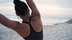 Fitness, stretching and woman on beach for exercise and warm up for run on beach, mockup for sports and wellness. Running, athlete and earphones for music, workout and sport training with back view.