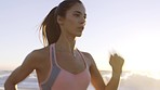 Woman, beach and sunset running, exercise and cardio training with strong mindset, freedom and focus for healthy fitness goals. Runner, athlete and workout at sea, nature and ocean for body wellness