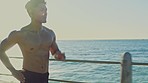 Fitness, exercise and Asian man running by the ocean for marathon training, endurance workout and cardio. Sports, nature and male runner doing sprint for body wellness, healthy lifestyle and muscles
