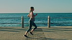 Pregnancy wellness, running on beach and outdoor fitness for prenatal healthcare, cardio exercise and body training with music. Pregnant woman, runner and audio podcast for ocean run motivation 