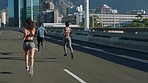 Running, city street and outdoor workout with people on urban bridge for fitness, exercise and cardio training for wellness. Woman and fast black man in speed race for marathon or competition