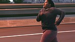 Plus size woman, running and city at night while listening to music for motivation during exercise, workout and cardio training to lose weight. Female run on urban bridge for obesity and weight loss