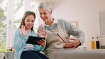 Tablet video call, wave and girl with grandmother, home cooking and communication on technology. Greeting, conversation and child blowing a kiss with a senior woman baking with an hello on tech