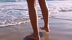 Woman, beach and feet walking along ocean on vacation, holiday or summer trip. Relax, travel or freedom with legs of female on seashore, coast or seaside playing by water and having fun time outdoors