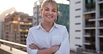 Business, woman and arms crossed on office building in city of New York with motivation, smile and mindset for goals, vision and trust. Portrait of happy female worker on rooftop with city background